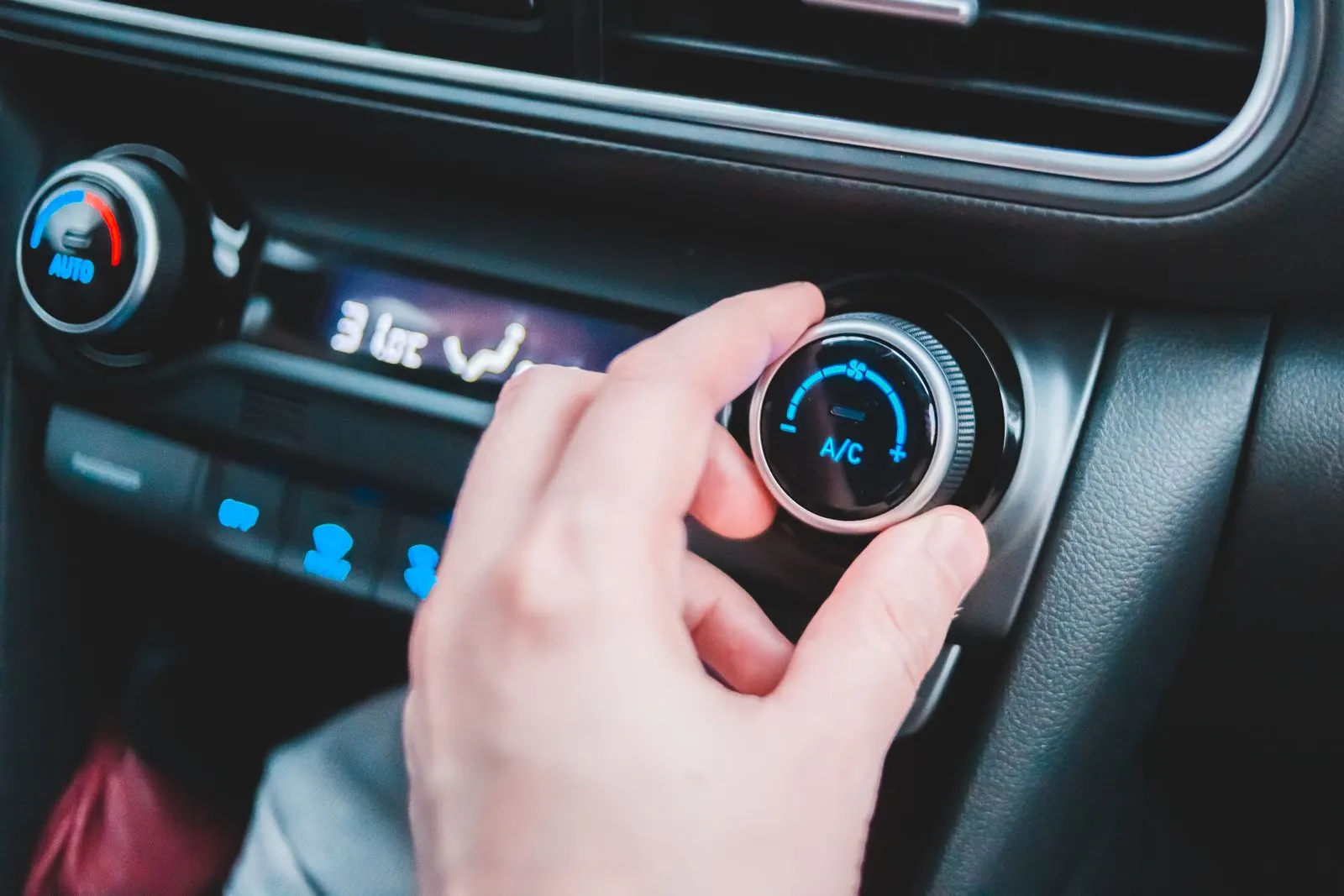 Turning the A/C dial in a car