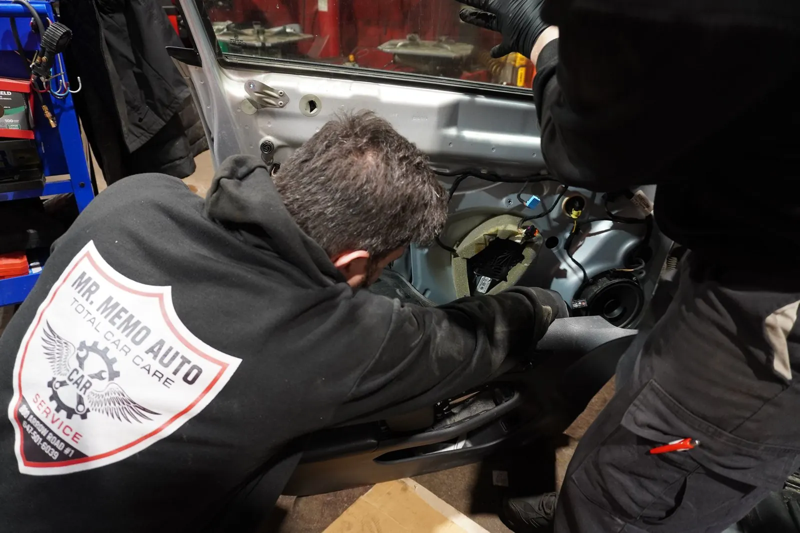Technician working inside a car door