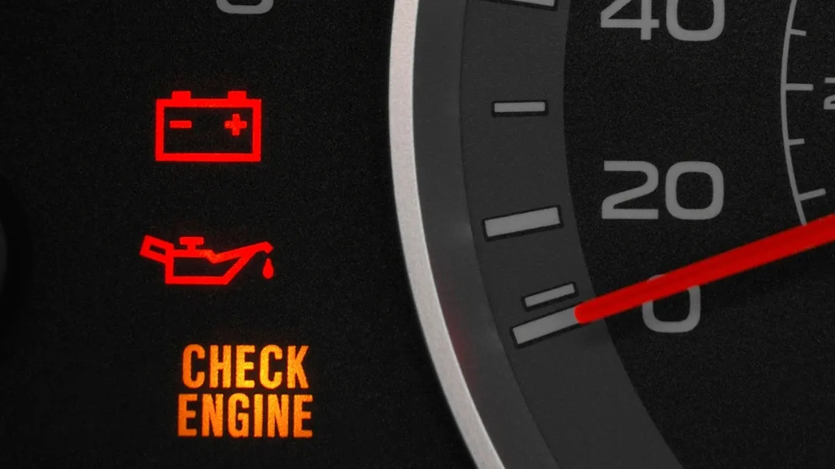 Check engine, oil and battery warning lights on a dashboard