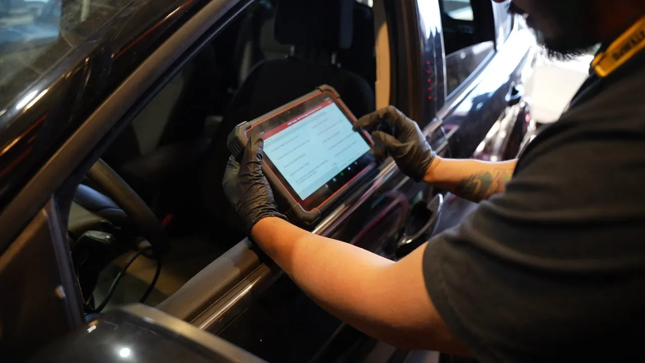 Technician scanning a car for trouble codes at Mr. Memo Auto
