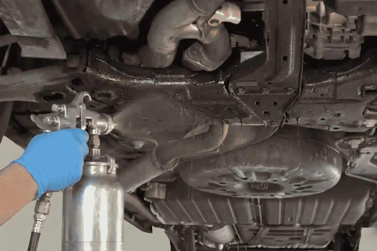 Rust proofing spray applied to a vehicle underbody